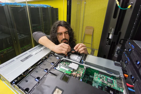 Man working with server in data center