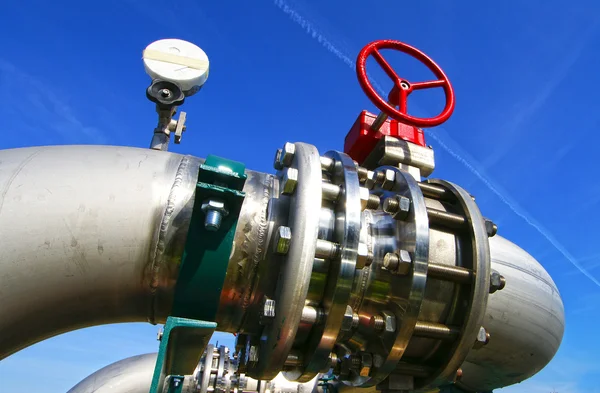 Industrial zone, Steel pipelines and valves against blue sky