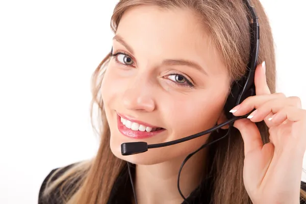 Beautiful call center employee smiling with a headset over white