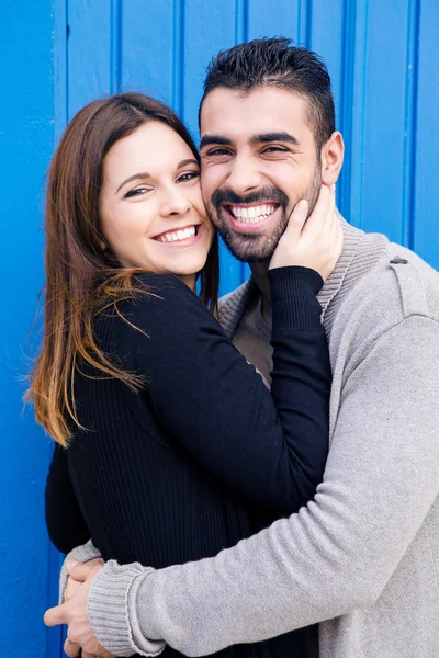 Couple hugging over blue background