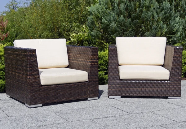 Outdoor furniture rattan armchairs on terrace garden
