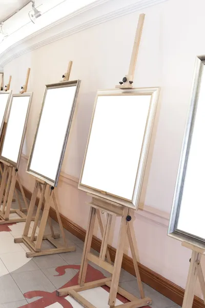 Corridor with blank frames on painting easel