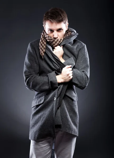 Young man in winter clothes shivering from cold