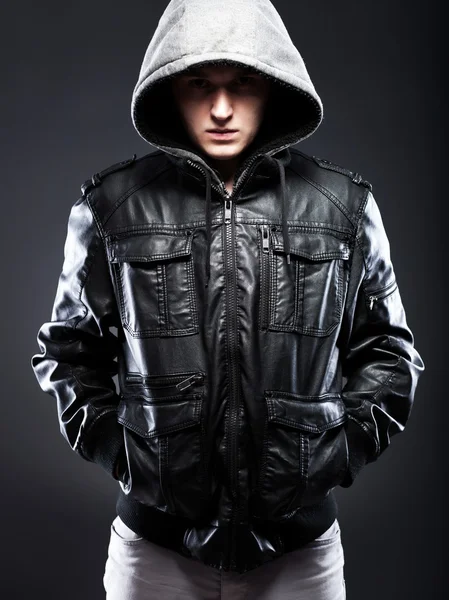 Young man in leather jacket with hood