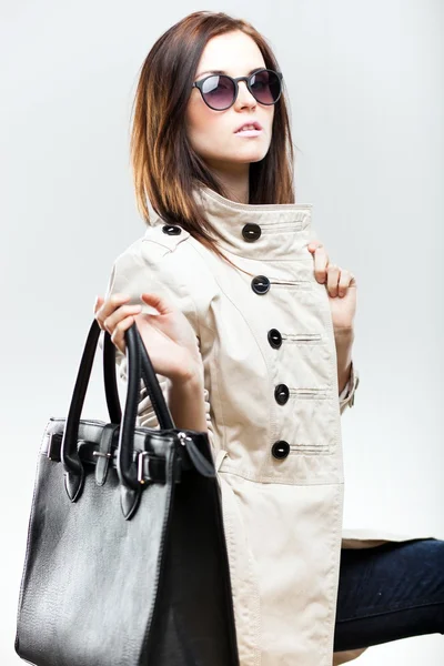 Fashionable woman with black leather bag