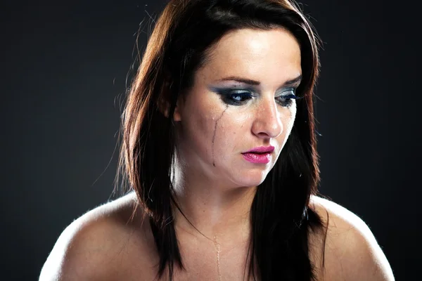Hurt woman crying, smeared makeup