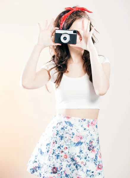 Pretty pin up girl vintage camera taking picture