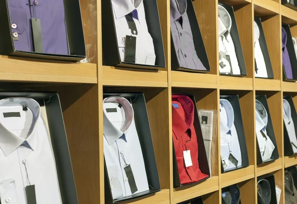 Elegant men shirt on shelves, apparel store