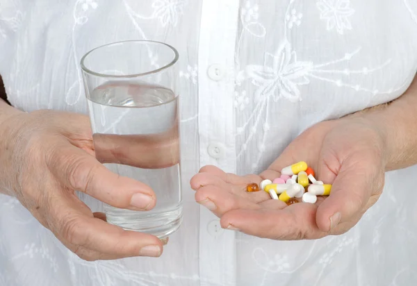Medical pills in elderly hand