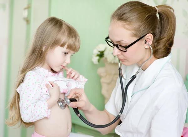 Doctor examining girl with stethoscope