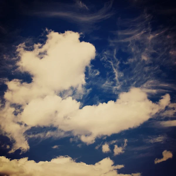 Blue sky and puffy clouds with a retro effect