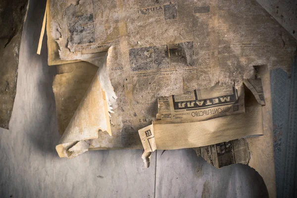 Old papers on wall in abandoned room