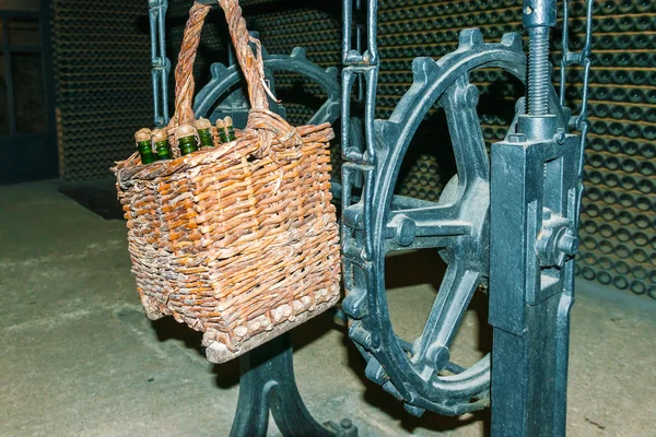 Basket with wine bottles in Codorniu winery.