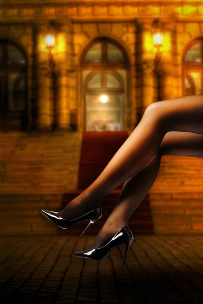 Woman's Legs Wearing Pantyhose and High Heels