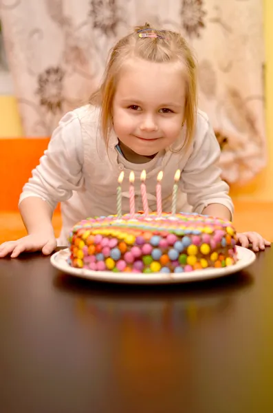 Cute little girl and birthday cake