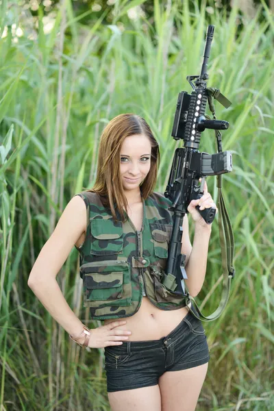 Sexy woman holding up her weapon