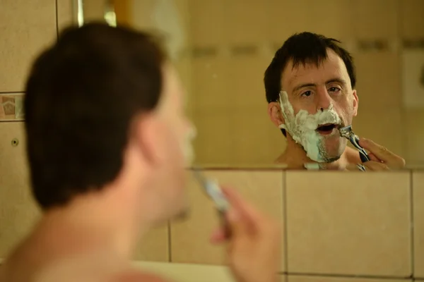 Down syndrome man shaving