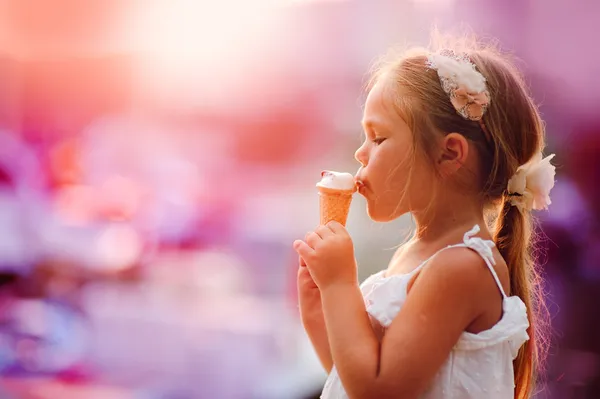 On seacoast the girl eats ice-cream