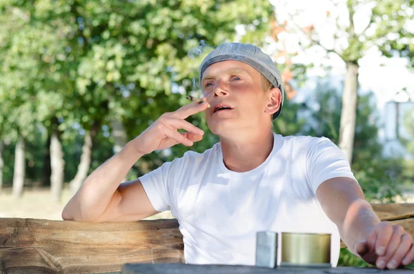 Man sitting outdoors smoking