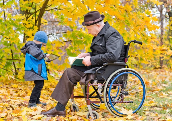 Elderly disabled man with his grandson