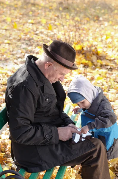 Grandfather and grandson sharing a tablet-pc