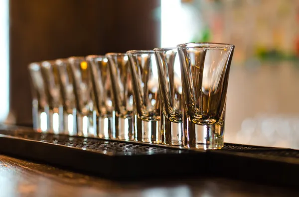 Row of empty glasses on a bar counter