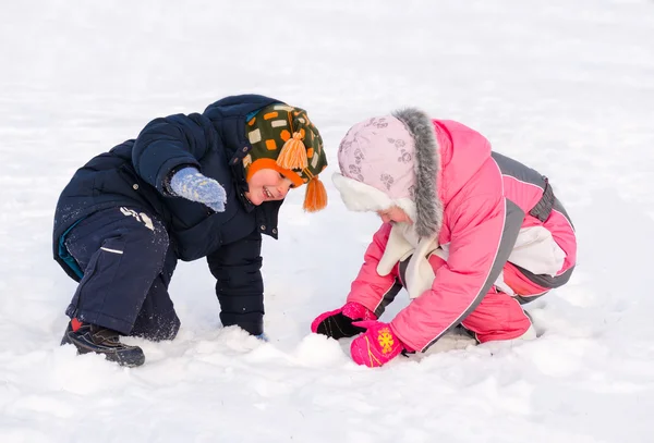 Young brother and sister playing in the snow — Stock Photo #37814155