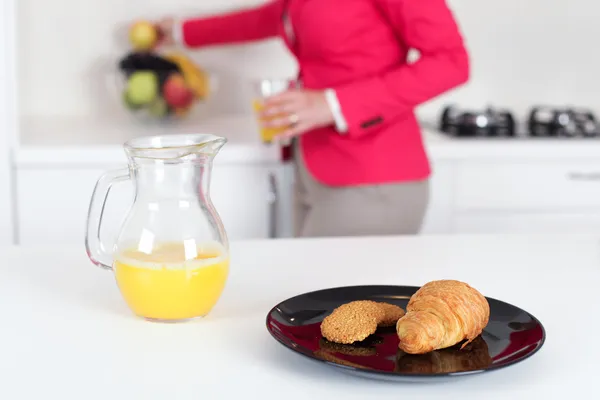 Businesswoman eating breakfast