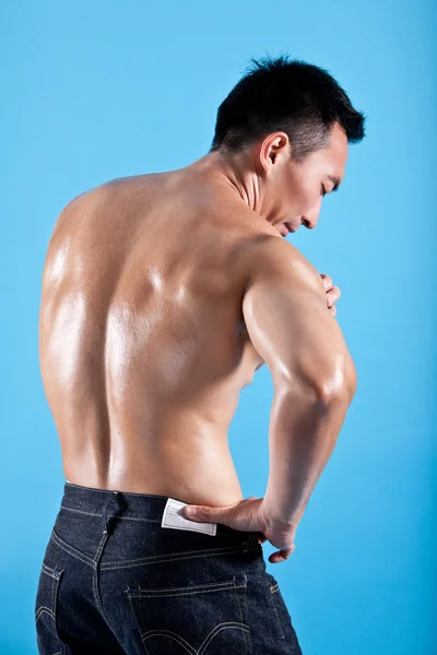 Young healthy man suffering from shoulder pain