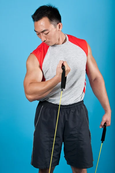 Young fit man with exercise stretch band