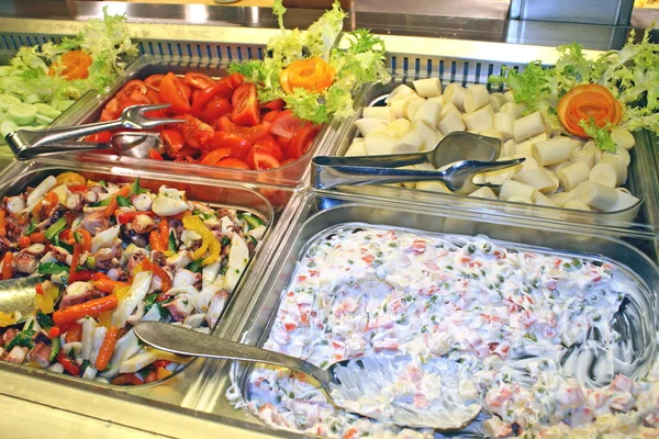Steel trays filled with great food in a self-service restaurant