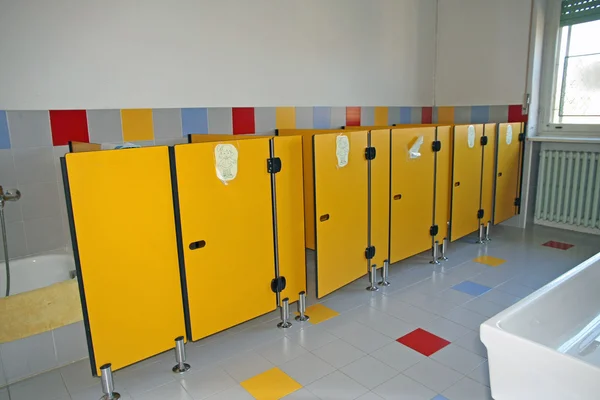 Small bathrooms with yellow doors of kindergarten