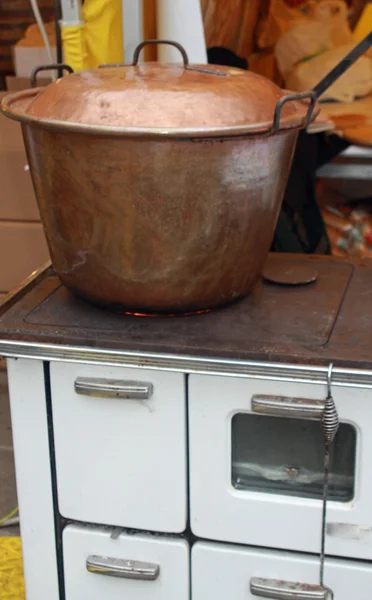 Copper cauldron over an old wood stove