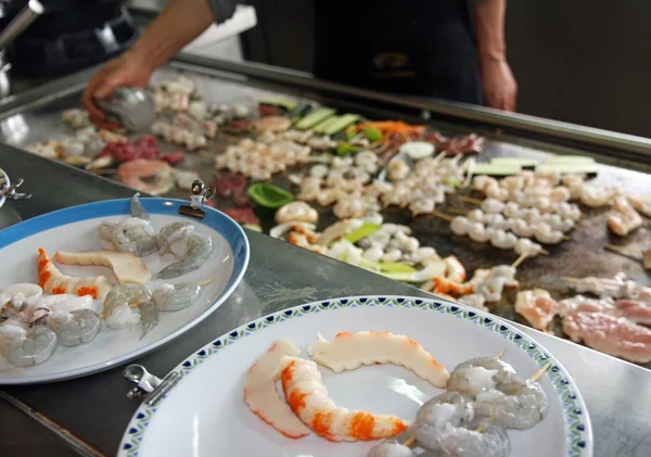 Chinese cook while it bakes vegetables fish and meat in plate