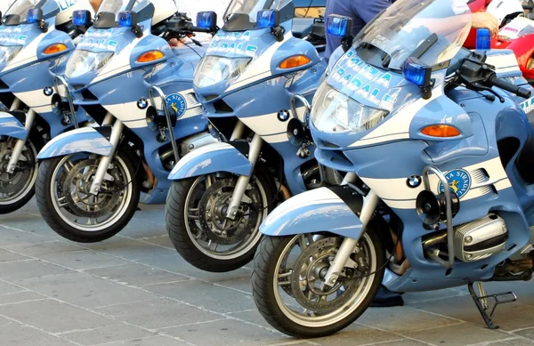 Police motorcycles lined up at a gathering of fans
