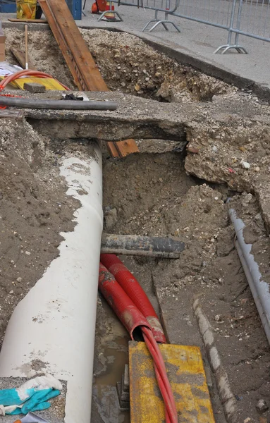 Digging for roadworks during the laying of a conduit for fiber o