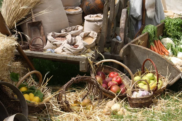 Cart and baskets with seasonal fruit and vegetables for sale at