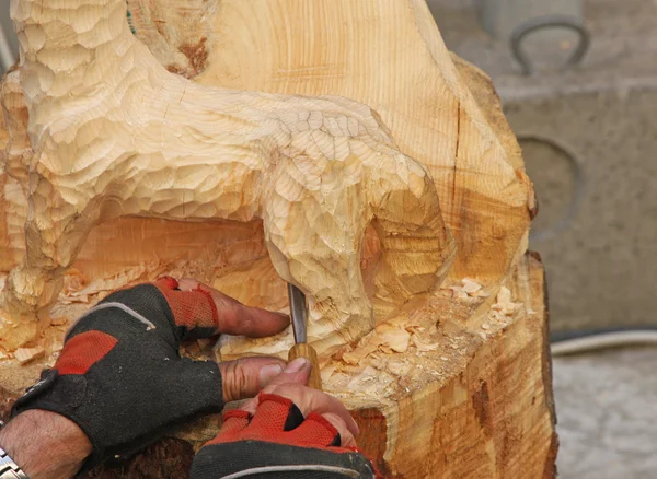 Expert hands with gloves of a craftsman who works with wood