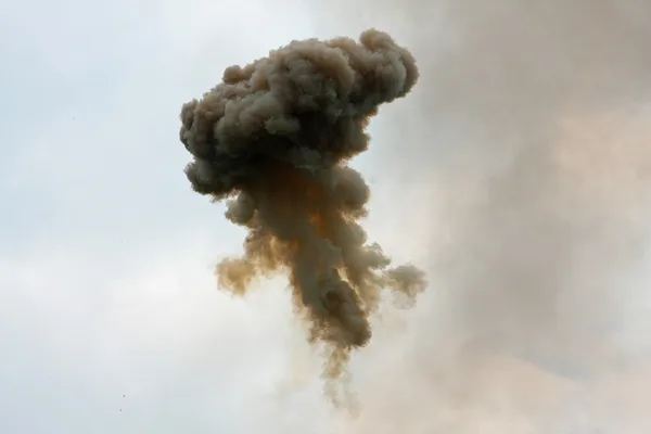 Dangerous and dramatic cloud of black smoke after an explosion i