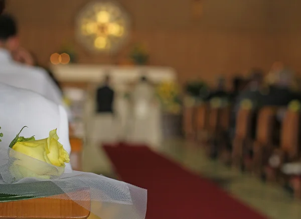 Christian Church during the rite of marriage with a yellow rose