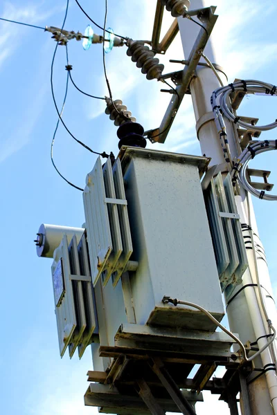 Electricity transformer mounted on a pole outdoors