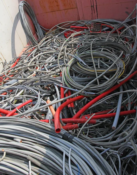 Many obsolete electrical cables and copper cables in a container