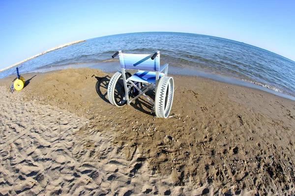 Wheelchairs with steel wheels on the beach