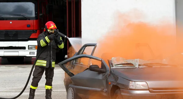 Fireman extinguishes the fire after car accident 2