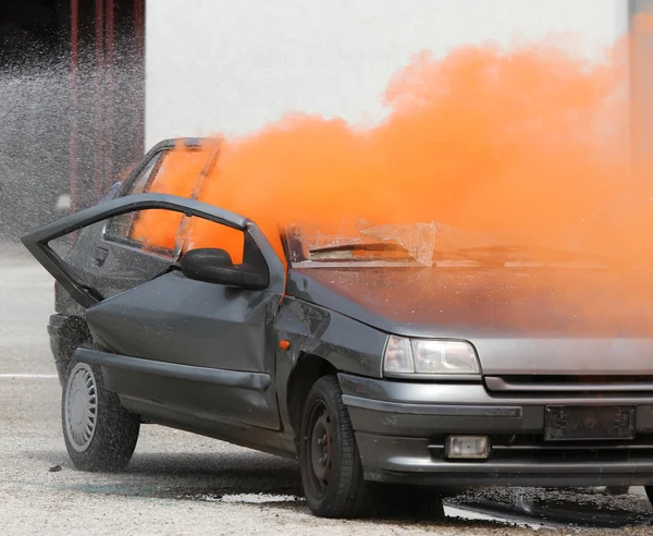 Orange smoke escapes from the car destroyed