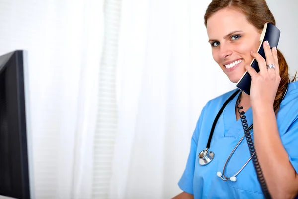 Beautiful blonde woman on blue medical uniform