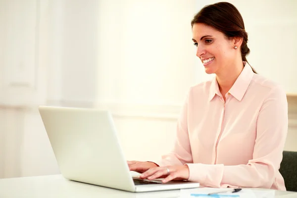 Beautiful 20s businesswoman using her laptop