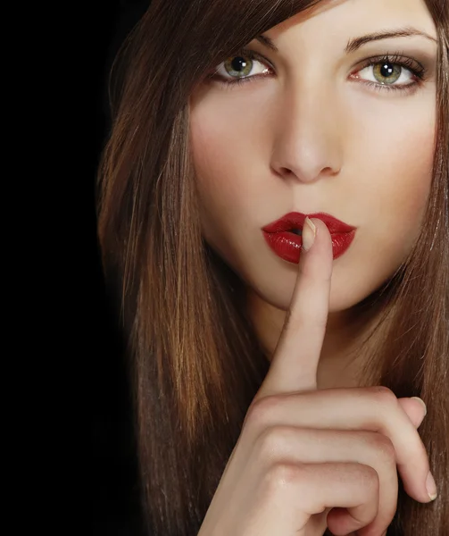 Portrait of attractive young girl with finger on lips, brown long hair, iso