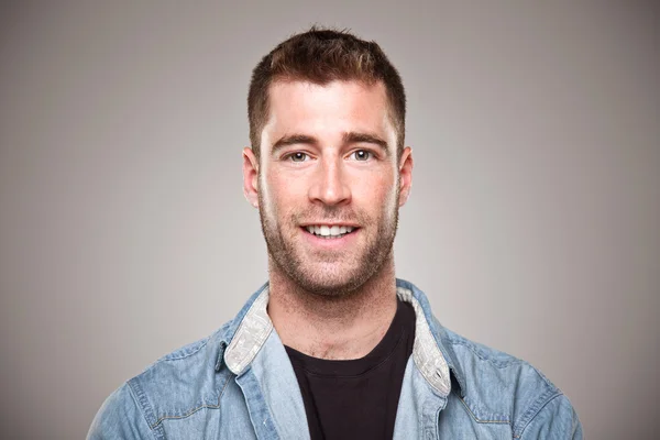 Portrait of a normal man smiling over grey background