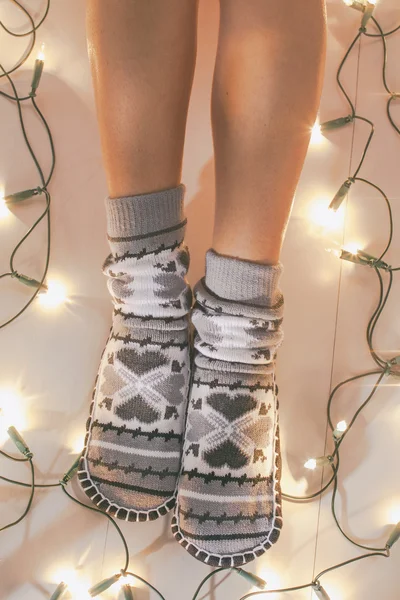 Woman with cozy socks on Christmas time.